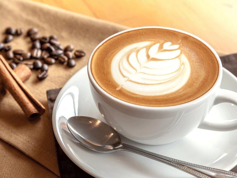 Coffee cup full of coffee sitting on a plate